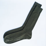 Pair of green socks with 'Kempt' branding on a white background
